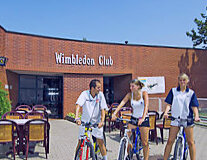 a group of people on a bicycle in front of a building